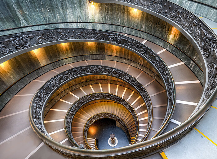 A spiral staircase seen from above, its stairs repeating in a continuous loop